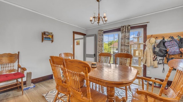 1345 Annie Ct, Sheboygan, WI 53083 - dining area featuring crown molding, a chandelier, and light wood-style flooring