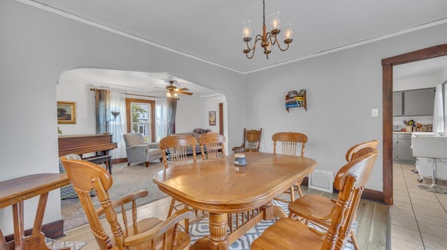 1345 Annie Ct, Sheboygan, WI 53083 - dining space featuring arched walkways, ornamental molding, and ceiling fan