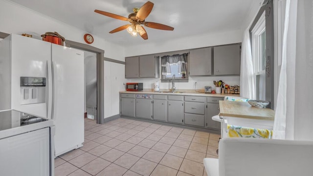 1345 Annie Ct, Sheboygan, WI 53083 - kitchen featuring gray cabinets, ceiling fan, light countertops, light tile patterned flooring, and electric range oven