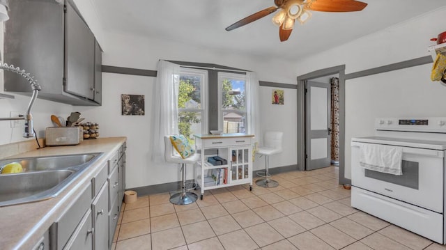 1345 Annie Ct, Sheboygan, WI 53083 - kitchen featuring electric stove, ceiling fan, light countertops, and light tile patterned floors