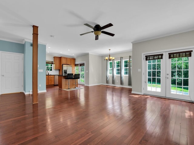 N8986 Swift Lake Dr, East Troy, WI 53120 - unfurnished living room featuring ceiling fan, a chandelier, ornamental molding, dark wood finished floors, and french doors