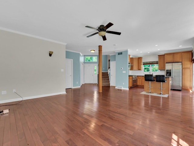 N8986 Swift Lake Dr, East Troy, WI 53120 - unfurnished living room with crown molding, ceiling fan, wood finished floors, stairway, and recessed lighting