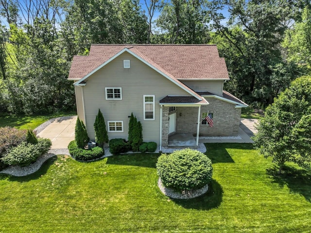 N8986 Swift Lake Dr, East Troy, WI 53120 - traditional-style house with a front lawn and a patio