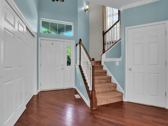 N8986 Swift Lake Dr, East Troy, WI 53120 - entryway with dark wood finished floors, stairs, and crown molding