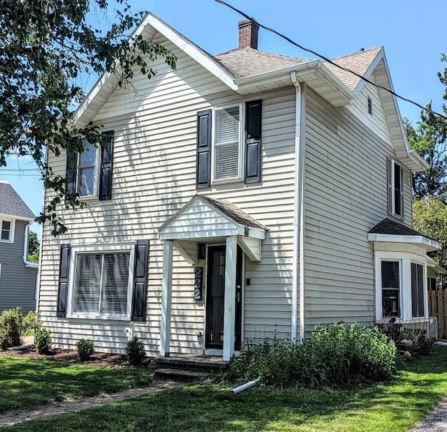 232 4th St, Neenah, WI 54956 - view of front of home featuring a chimney, a front yard, and a shingled roof