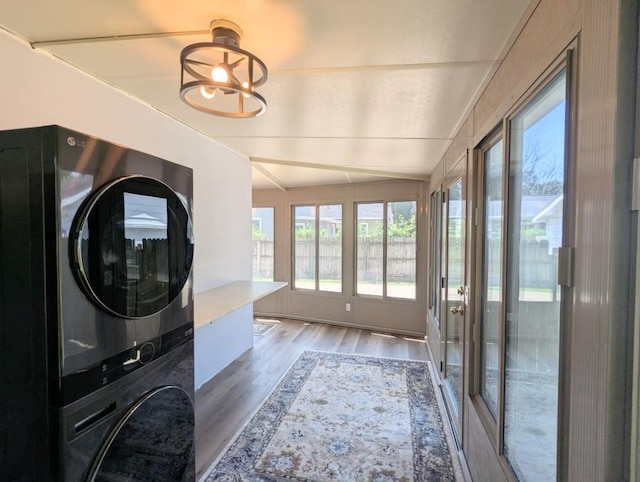 232 4th St, Neenah, WI 54956 - laundry area featuring stacked washer and clothes dryer and wood finished floors