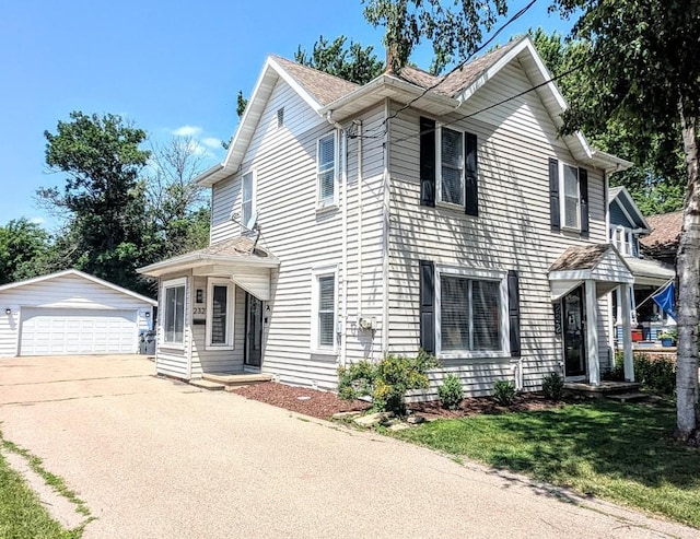 232 4th St, Neenah, WI 54956 - view of front of house with an outdoor structure, a detached garage, and a front yard