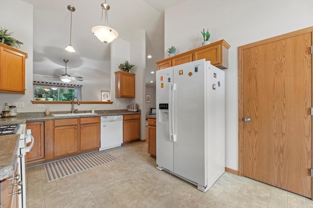 10724 S Christina Ct, Oak Creek, WI 53154 - kitchen featuring white appliances, a ceiling fan, brown cabinets, a towering ceiling, and hanging light fixtures