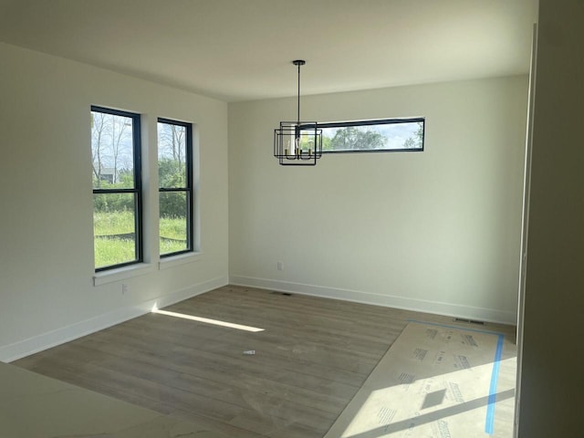 N75W17841 Woody Ln, Menomonee Falls, WI 53051 - unfurnished room featuring a chandelier and wood finished floors