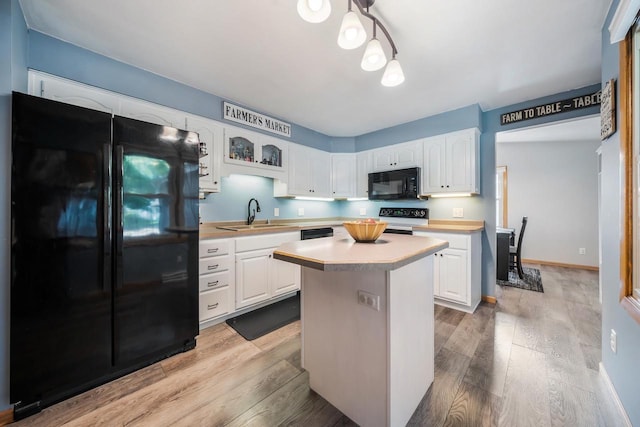 531 E Taft Ave, Appleton, WI 54915 - kitchen with black appliances, light countertops, and white cabinetry