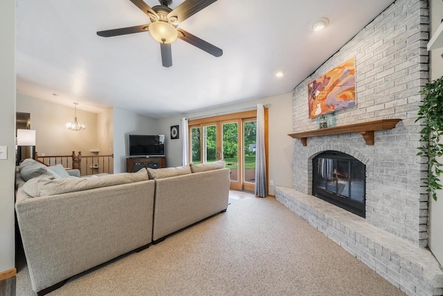 531 E Taft Ave, Appleton, WI 54915 - living room featuring a ceiling fan, a brick fireplace, a chandelier, and carpet floors