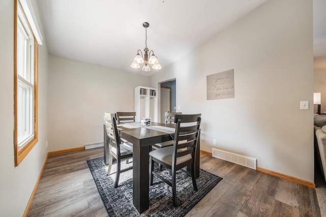 531 E Taft Ave, Appleton, WI 54915 - dining area featuring a chandelier, wood finished floors, healthy amount of natural light, a baseboard radiator, and vaulted ceiling