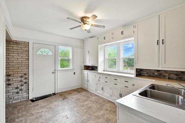 6222 W Locust St Unit 6224, Milwaukee, WI 53210 - kitchen featuring ceiling fan, white cabinets, light countertops, and brick wall