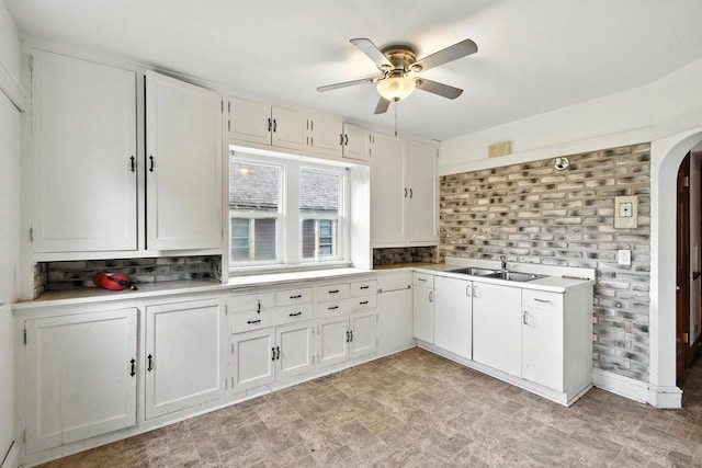 6222 W Locust St Unit 6224, Milwaukee, WI 53210 - kitchen featuring ceiling fan, arched walkways, light countertops, and backsplash