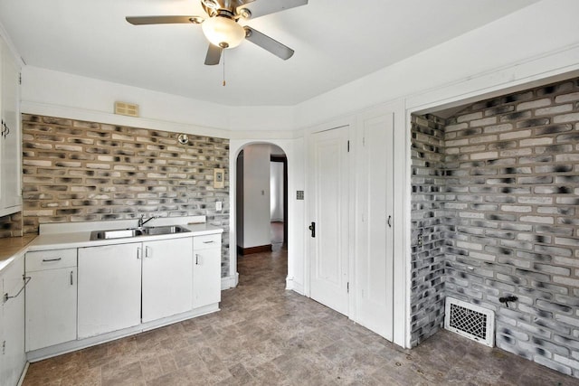 6222 W Locust St Unit 6224, Milwaukee, WI 53210 - kitchen with arched walkways, light countertops, ceiling fan, and white cabinetry