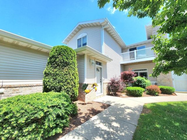 4023 Hazelnut Ct, Sheboygan, WI 53081 - view of front facade with stone siding and a balcony