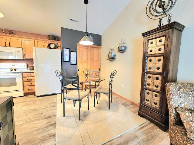 4023 Hazelnut Ct, Sheboygan, WI 53081 - dining space featuring light wood-style floors and vaulted ceiling