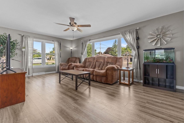 2015 E College Ave, Appleton, WI 54915 - living area featuring wood finished floors, plenty of natural light, and a ceiling fan