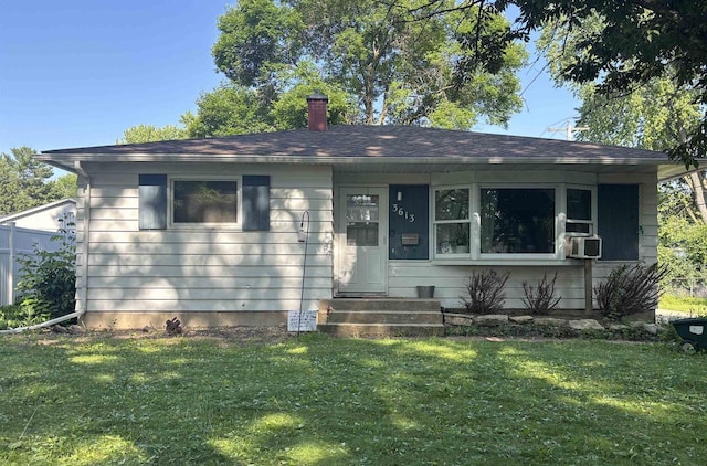 3613 Spenser Ln, Madison, WI 53704 - view of front of house featuring a front lawn, cooling unit, and a chimney