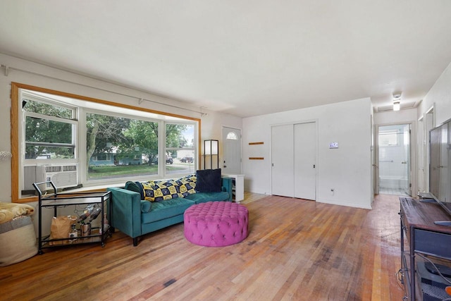3613 Spenser Ln, Madison, WI 53704 - living area featuring wood finished floors, plenty of natural light, and cooling unit