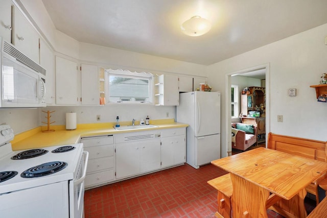 3613 Spenser Ln, Madison, WI 53704 - kitchen with white appliances, light countertops, brick patterned flooring, and white cabinetry