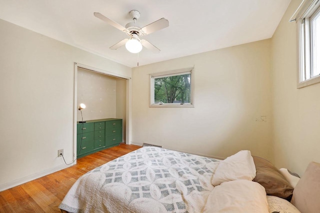 3613 Spenser Ln, Madison, WI 53704 - bedroom featuring multiple windows, light wood finished floors, and a ceiling fan