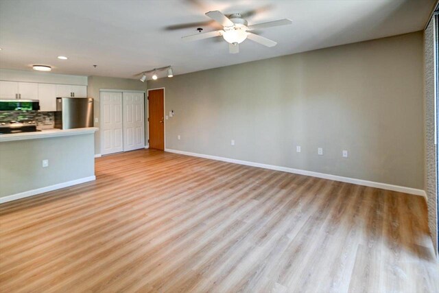201 Kearney Way Unit 201, Waunakee, WI 53597 - unfurnished living room featuring light wood-style flooring, ceiling fan, track lighting, and recessed lighting