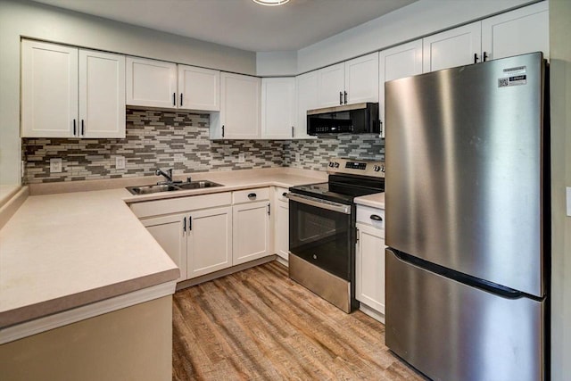 201 Kearney Way Unit 201, Waunakee, WI 53597 - kitchen with stainless steel appliances, light countertops, decorative backsplash, and white cabinets