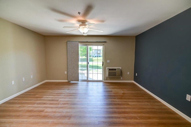 201 Kearney Way Unit 201, Waunakee, WI 53597 - spare room with an AC wall unit, a ceiling fan, and wood finished floors