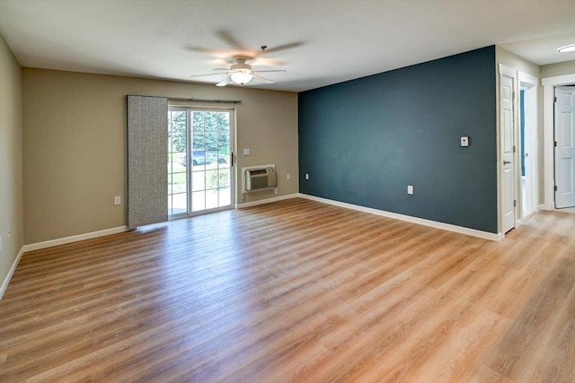201 Kearney Way Unit 201, Waunakee, WI 53597 - unfurnished room with ceiling fan, a wall mounted air conditioner, and light wood-style floors
