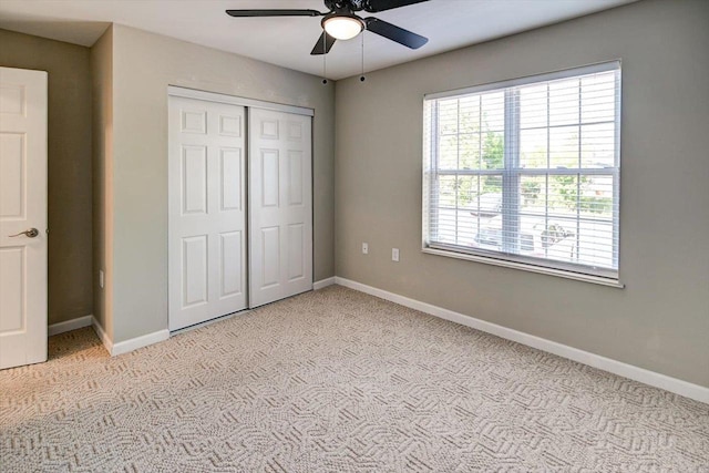 201 Kearney Way Unit 201, Waunakee, WI 53597 - unfurnished bedroom with light colored carpet, a closet, and ceiling fan