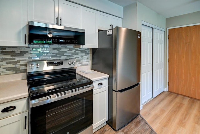 201 Kearney Way Unit 201, Waunakee, WI 53597 - kitchen with appliances with stainless steel finishes, light countertops, light wood-type flooring, and white cabinetry