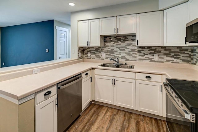 201 Kearney Way Unit 201, Waunakee, WI 53597 - kitchen with stainless steel appliances, a peninsula, tasteful backsplash, white cabinets, and recessed lighting