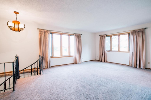 403 Bluebird Ln, Loyal, WI 54446 - carpeted empty room featuring a chandelier and plenty of natural light
