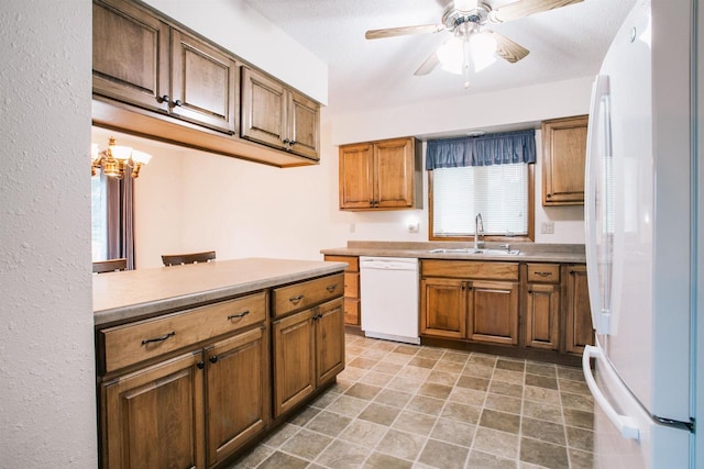 403 Bluebird Ln, Loyal, WI 54446 - kitchen featuring white appliances, ceiling fan, brown cabinetry, and healthy amount of natural light