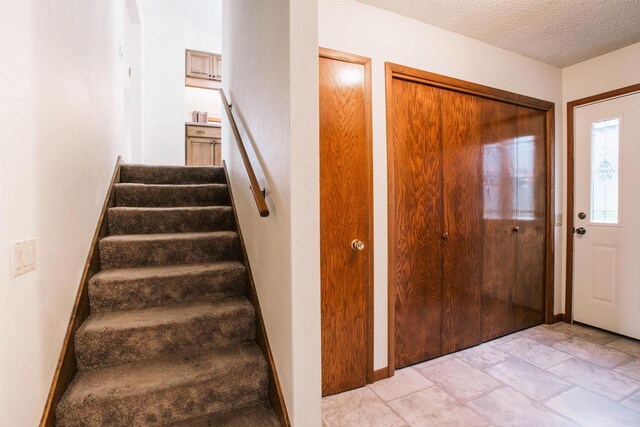 403 Bluebird Ln, Loyal, WI 54446 - foyer entrance featuring stairs and a textured ceiling