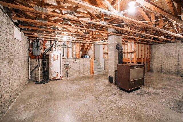 403 Bluebird Ln, Loyal, WI 54446 - unfinished below grade area with water heater, stairway, and brick wall