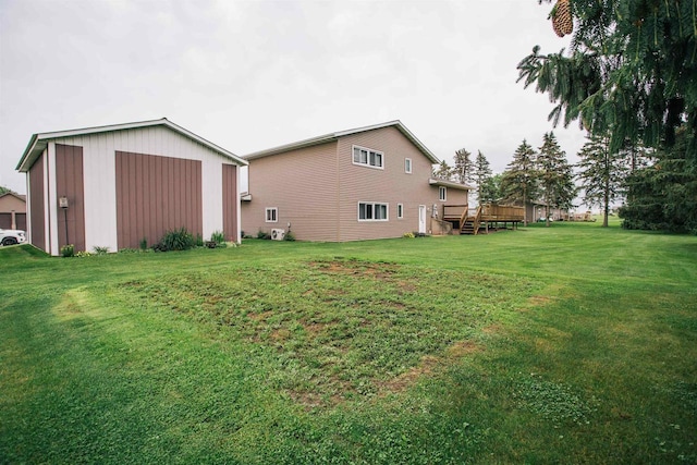 403 Bluebird Ln, Loyal, WI 54446 - view of green lawn featuring an outbuilding, a deck, and a pole building