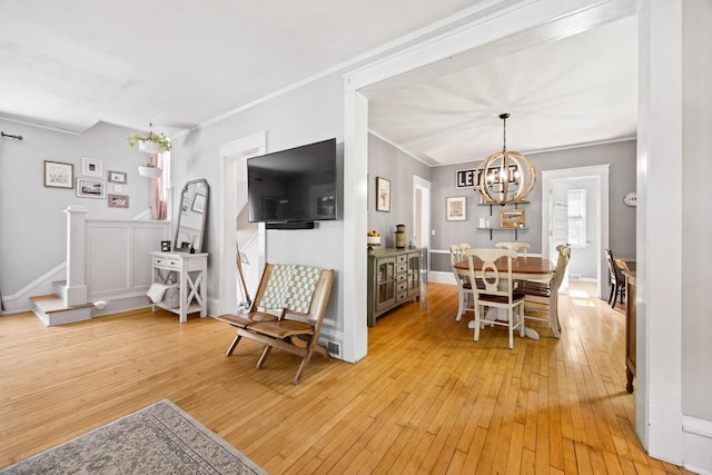 622 Grant St, Fort Atkinson, WI 53538 - dining area with a chandelier, light wood-style floors, and ornamental molding