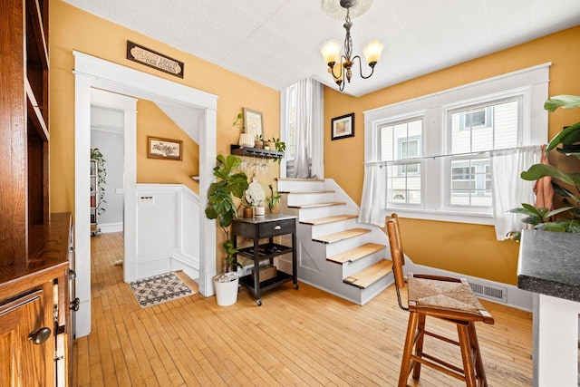 622 Grant St, Fort Atkinson, WI 53538 - foyer entrance with light wood-style flooring, a chandelier, and stairway