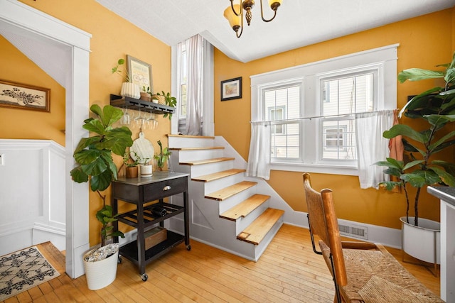 622 Grant St, Fort Atkinson, WI 53538 - staircase featuring wood-type flooring and a chandelier
