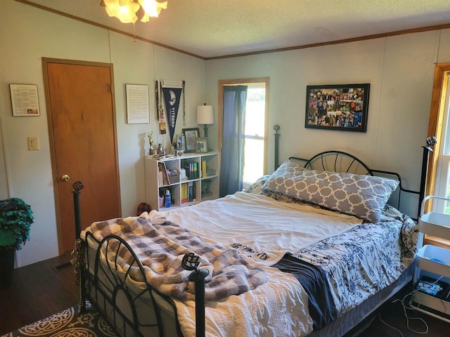 W6747 Legler Valley Rd, New Glarus, WI 53574 - bedroom with crown molding, vaulted ceiling, a textured ceiling, and wood finished floors