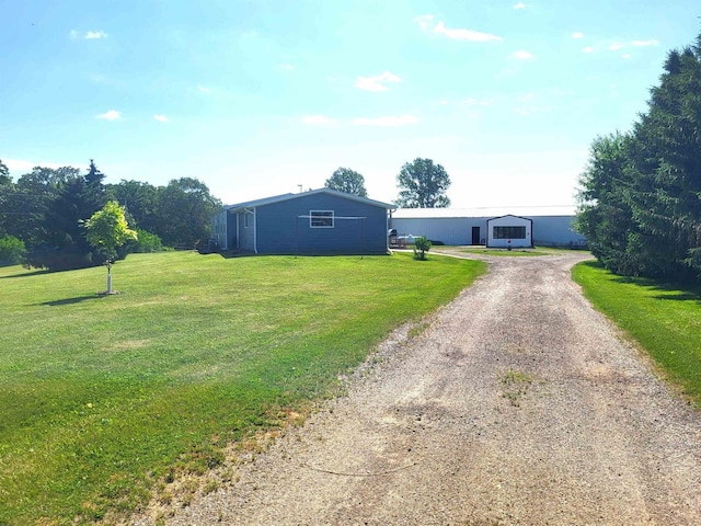 W6747 Legler Valley Rd, New Glarus, WI 53574 - view of front of house with driveway, a front yard, and an outdoor structure