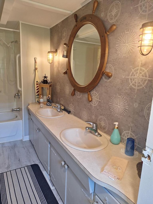 1412 Park St Unit 13, Burlington, WI 53105 - bathroom featuring wallpapered walls, double vanity,  shower combination, and wood finished floors