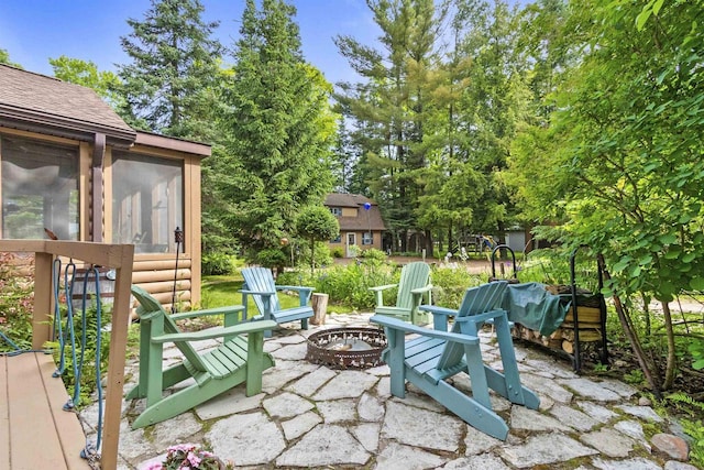17705 Nicolet Rd, Townsend, WI 54175 - view of patio featuring a fire pit and a sunroom