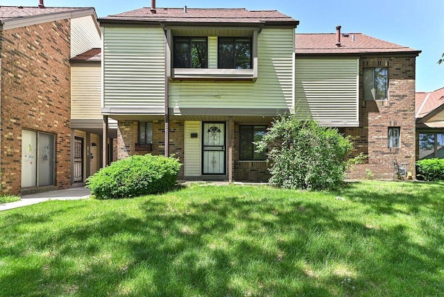 9618 W Bradley Rd, Milwaukee, WI 53224 - townhome / multi-family property with a front lawn and brick siding