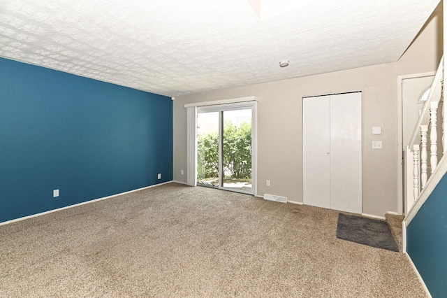 9618 W Bradley Rd, Milwaukee, WI 53224 - unfurnished room with a textured ceiling, carpet floors, and stairs