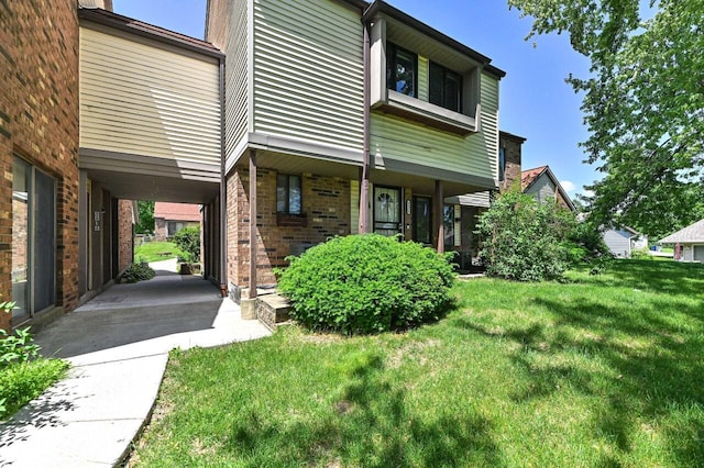 9618 W Bradley Rd, Milwaukee, WI 53224 - view of front of house featuring brick siding, a front yard, and a porch