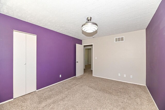 9618 W Bradley Rd, Milwaukee, WI 53224 - unfurnished bedroom with carpet floors, a textured ceiling, and a closet