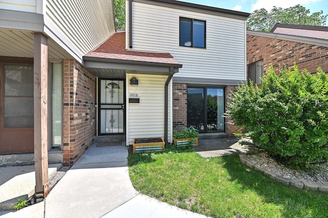 9618 W Bradley Rd, Milwaukee, WI 53224 - doorway to property with brick siding and covered porch